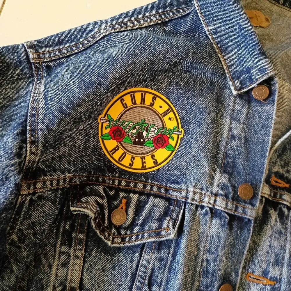 Vintage 1980'S Levi's jean jacket with rock band patches on it. Size large.